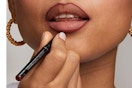 woman applying lip liner
