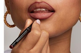 woman applying lip liner