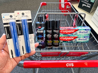 two Covergirl mascaras, one Axe body wash, two Tresemme hair sprays, and two Colgate Max Fresh toothpaste inside CVS shopping cart