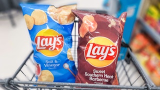 two bags of lays chips in shopping cart
