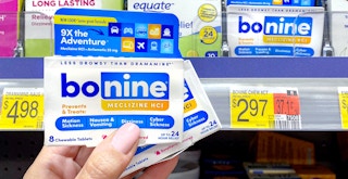 person holding packages of bonine meclizine near walmart shelf with price