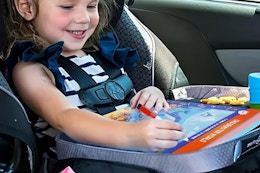 child using busy book in car