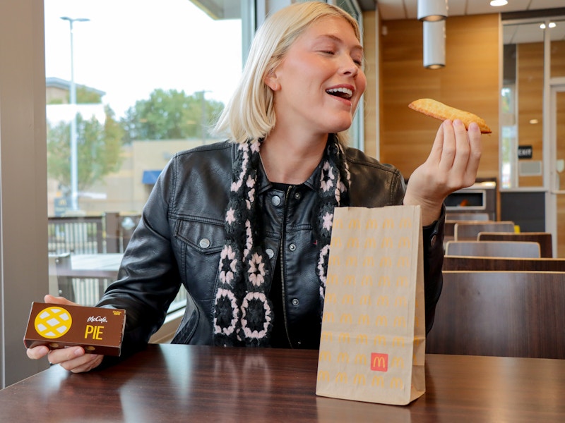 a person holding up a mcdonalds pie