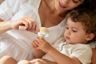 mother trimming her child's finger nails