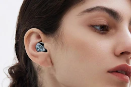 woman wearing black ear plugs