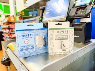 2 Mrs. Meyer's diffusers sitting in front of a Walmart checkout