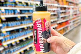 hand holding a bottle of guy fieris flavortown sauce