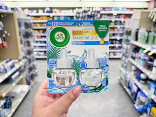 hand holding air wick refills in walgreens