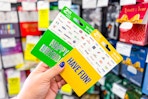 person holding 2 gift cards by the display