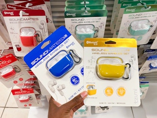 hand holding wireless earbuds