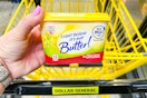 hand holding a tub of i cant believe its not butter