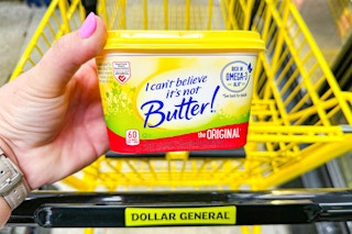 hand holding a tub of i cant believe its not butter