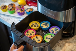 muffin batter in silicone muffin cups, in an air fryer