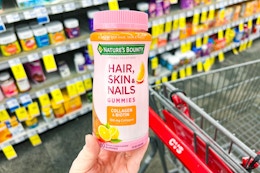 hand holding natures bounty hair skin and nails gummies