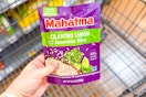hand holding a pack of mahatma rice