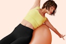 a woman wearing high waisted leggings while stretching
