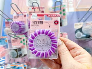 Woman holding invisibobble hair tie