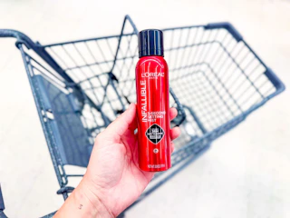 hand holding loreal infallible setting mist in walgreens