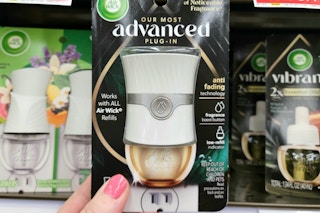 hand holding an air wick advanced scented oil warmer