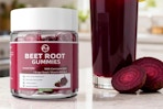 container of beet root gummies next to drink and beat