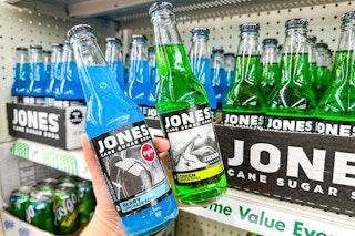 person holding 2 bottles of jones soda