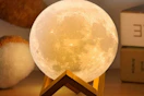 a moon lamp on a desk