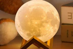 a moon lamp on a desk