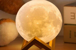 a moon lamp on a desk