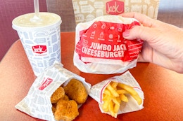 jack in the box value menu items on table with jr jack burger being held up