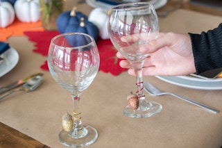 A wine glass with a homemade acorn charm on the bottom.