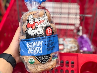 hand holding dave's killer bread bagels at target