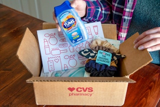 Someone opening up a CVS delivery box