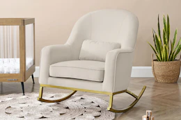 Lifestyle image of a velvet rocking chair in nursery setting