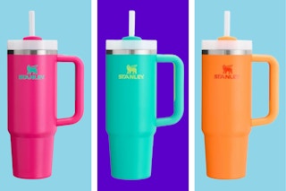 Pink, teal, and orange Stanley 30-ounce tumblers on a blue and purple collage background.