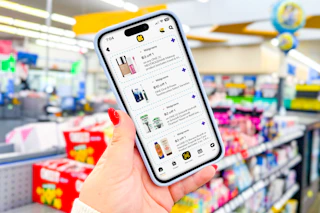 hand holiding smartphone displaying 1-clip coupons in the kcl app