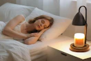 a candle warmer on a desk next to a person sleeping