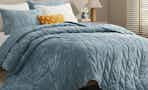 ash blue velvet quilt on bed
