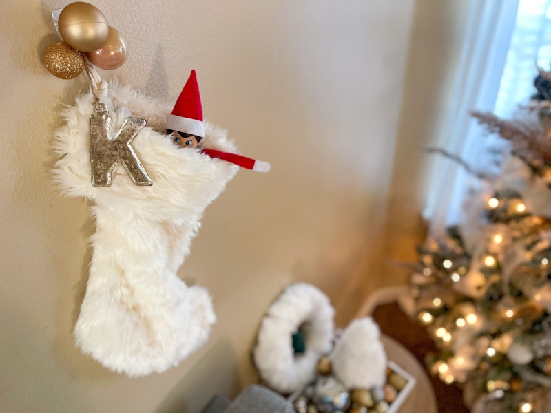 elf on the shelf doll hiding in a stocking 