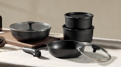 black pots and pans with lids on a table 