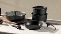 black pots and pans with lids on a table 