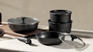 black pots and pans with lids on a table