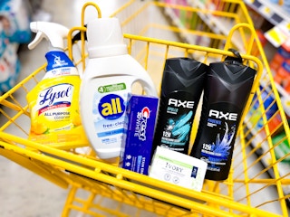 lysol spray, all detergent, crest toothpaste, ivory bar soap and 2 axe body washes in a cart