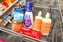 neutrogena moisturizer, shea moisture hair gel, colgate toothpaste, crest mouthwash, and sheamoisture shampoo in a cart