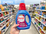 hand holding persil detergent in walgreens