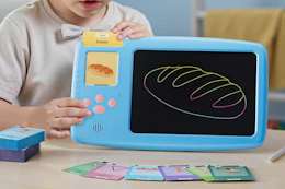 child playing with learning LCD tablet