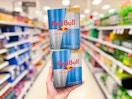 2 4-packs of Sugar Free Red Bull held up in center isle at Target