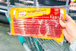 hand holding a pack of oscar mayer bacon