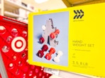 all in motion hand weight set sitting on a shelf with a target cart parked