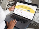 A person using a laptop looking at the GoodRx.com homepage
