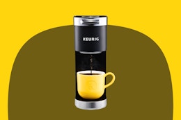 Stock image of the Keurig Mini Coffee maker in back with a yellow coffee mug
